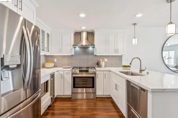 a kitchen with a sink stove and refrigerator