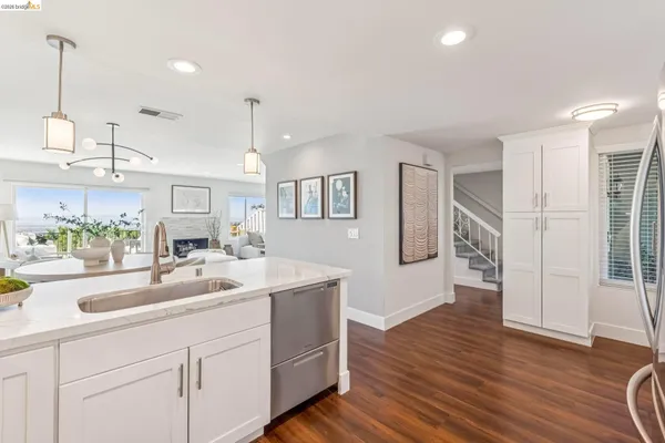 a kitchen with sink and refrigerator
