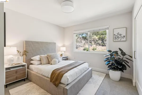 a bedroom with a large bed and a potted plant