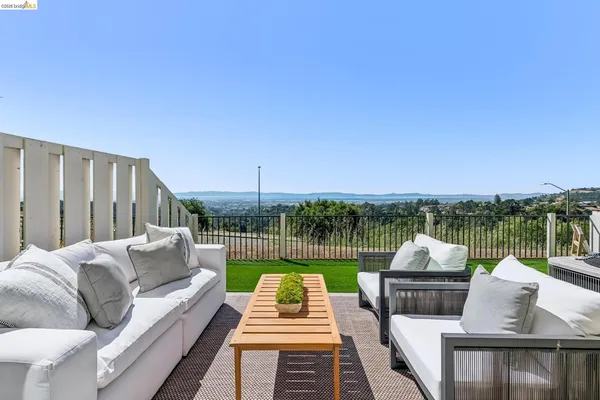 a view of a patio with couches and a table and chairs