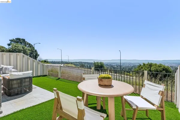 a view of a chair and table on the patio