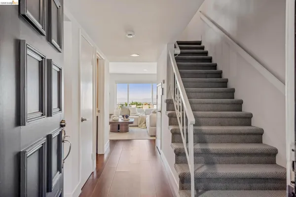 a view of entryway and hall with wooden floor
