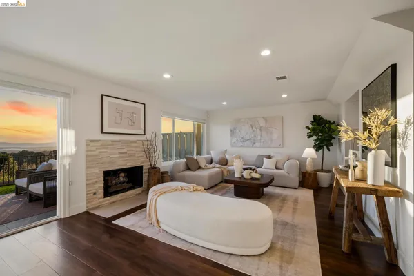a living room with furniture fireplace and potted plants