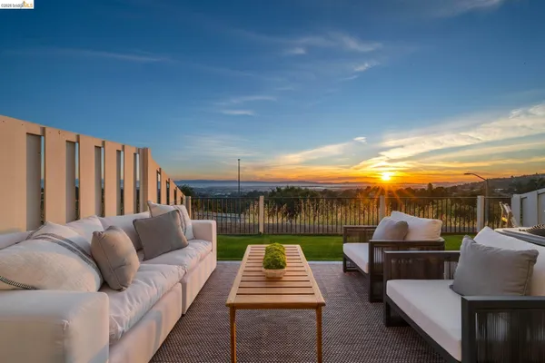 a balcony with furniture and a garden