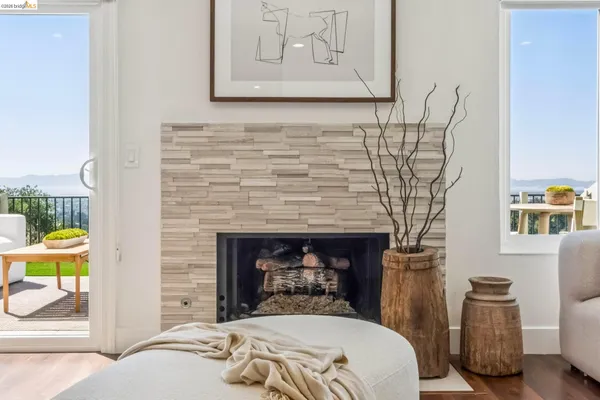 a bed sitting in a bedroom next to a window with a balcony