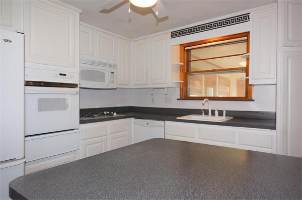 23 Jeffrey Road Arlington, MA 02474 - Photo 6 of 18 a kitchen with granite countertop white cabinets and white appliances