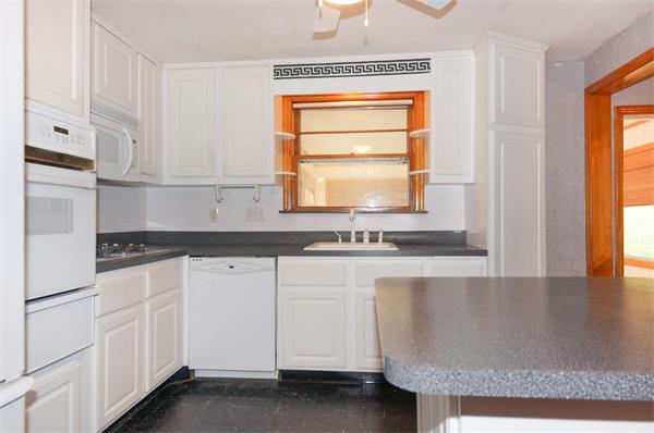 23 Jeffrey Road Arlington, MA 02474 - Photo 7 of 18 a kitchen with granite countertop white cabinets and white appliances