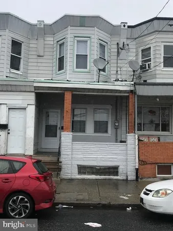 a front view of a house with parking space