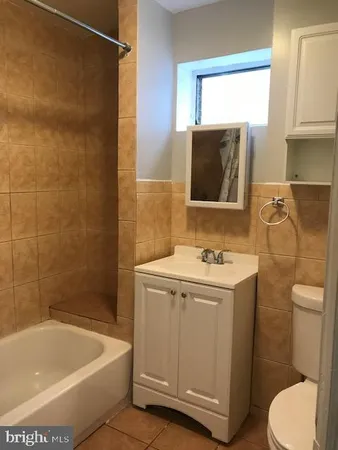 a bathroom with a sink a toilet and bathtub