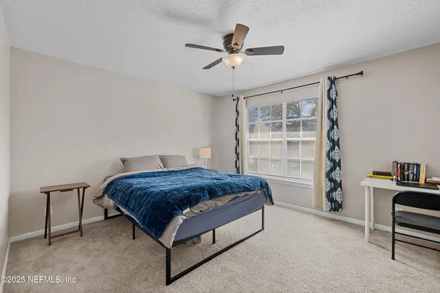 a living room with a bed furniture and a window