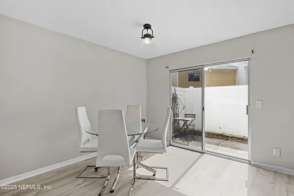 a living room with furniture and a glass door