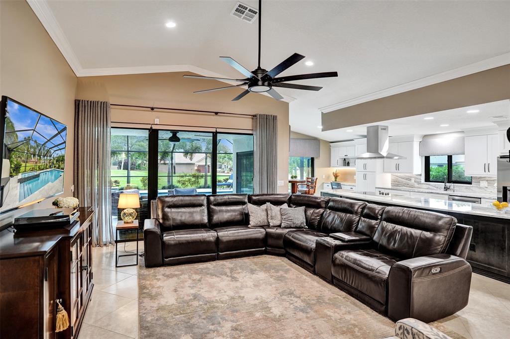 21357 Bridgeview Drive Boca Raton, FL 33428 - Photo 16 of 54 a living room with furniture and a flat screen tv