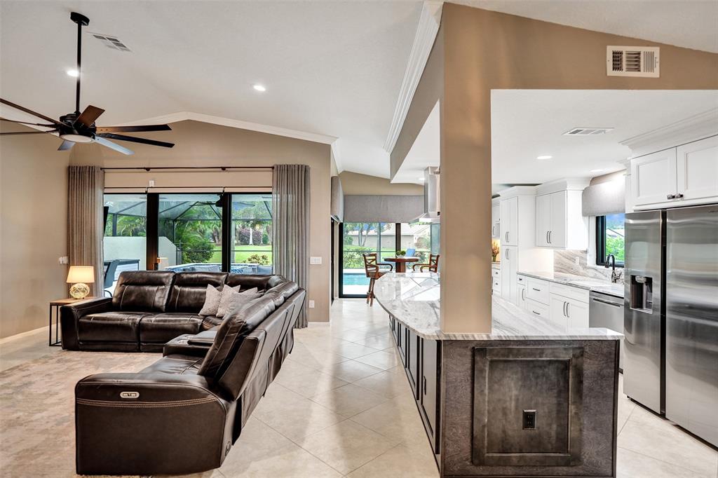 21357 Bridgeview Drive Boca Raton, FL 33428 - Photo 20 of 54 a dining room with furniture and a floor to ceiling window