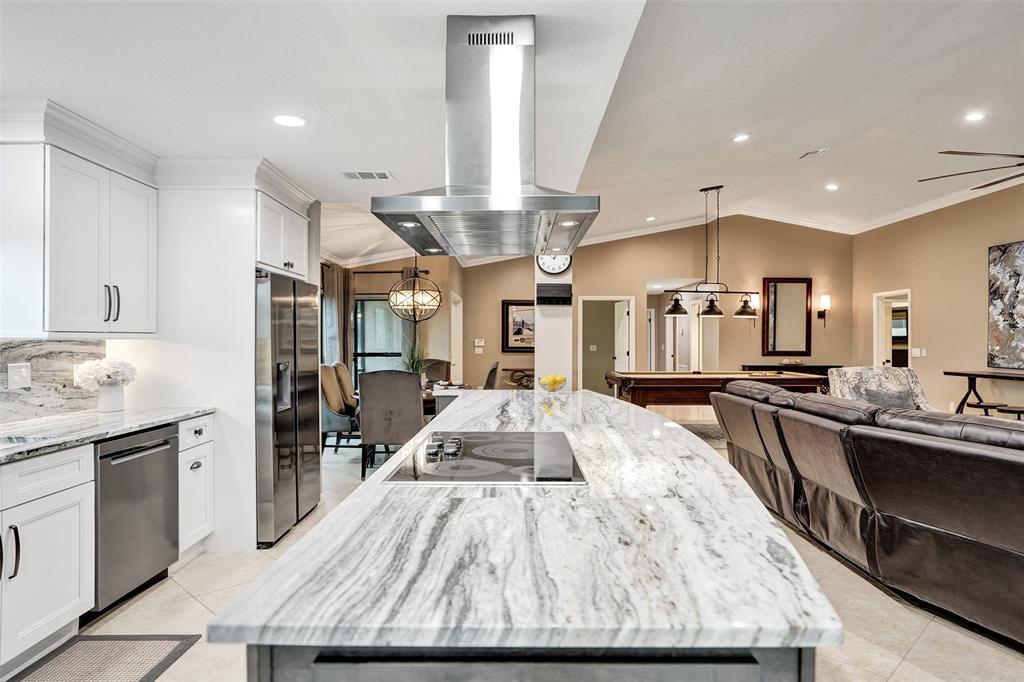 21357 Bridgeview Drive Boca Raton, FL 33428 - Photo 26 of 54 a large kitchen with stainless steel appliances kitchen island granite countertop a large counter top and wooden floors