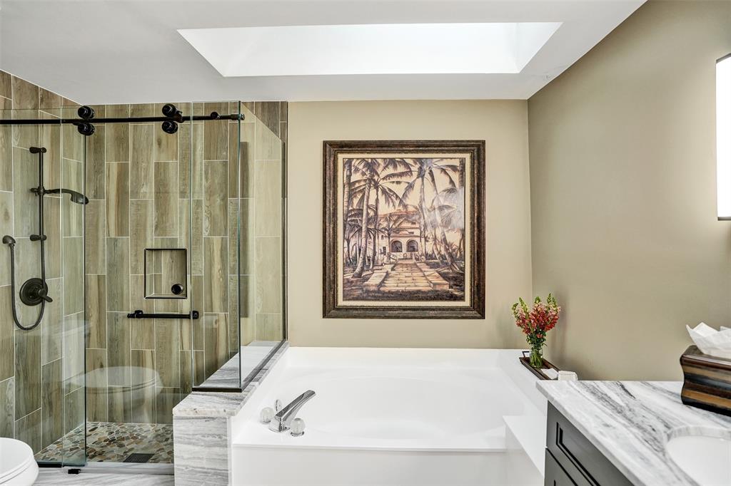 21357 Bridgeview Drive Boca Raton, FL 33428 - Photo 32 of 54 a bathroom with a granite countertop sink a toilet and shower