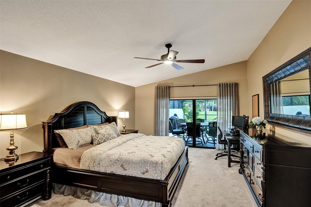 21357 Bridgeview Drive Boca Raton, FL 33428 - Photo 34 of 54 a bed room with a bed and a large mirror