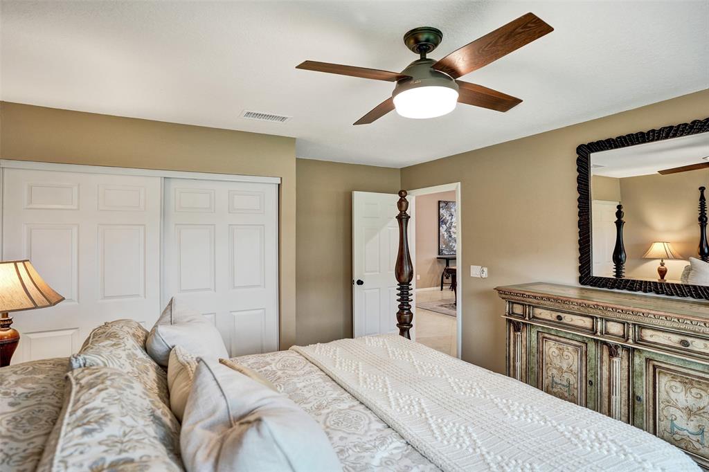 21357 Bridgeview Drive Boca Raton, FL 33428 - Photo 38 of 54 a bedroom with a bed and a chandelier