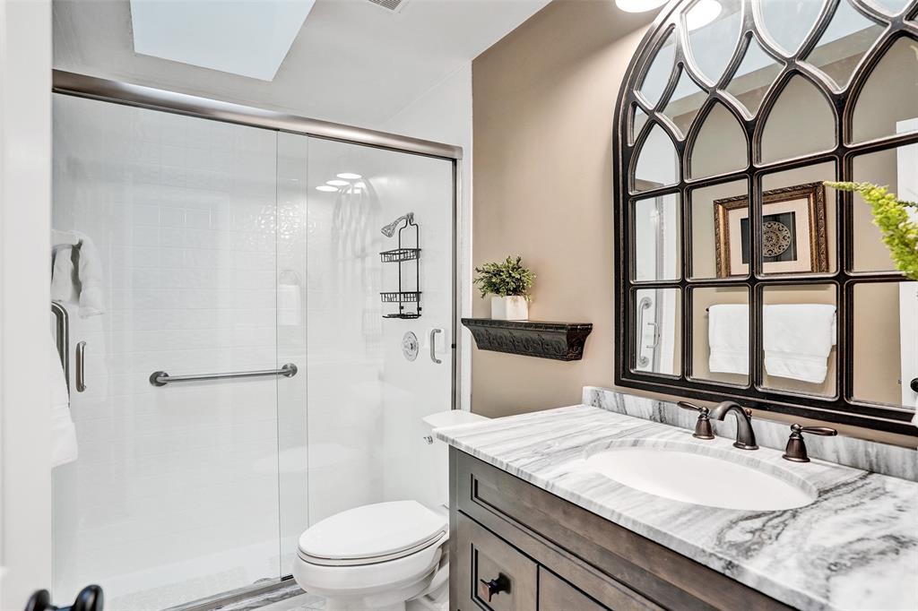 21357 Bridgeview Drive Boca Raton, FL 33428 - Photo 39 of 54 a bathroom with a granite countertop sink toilet and shower