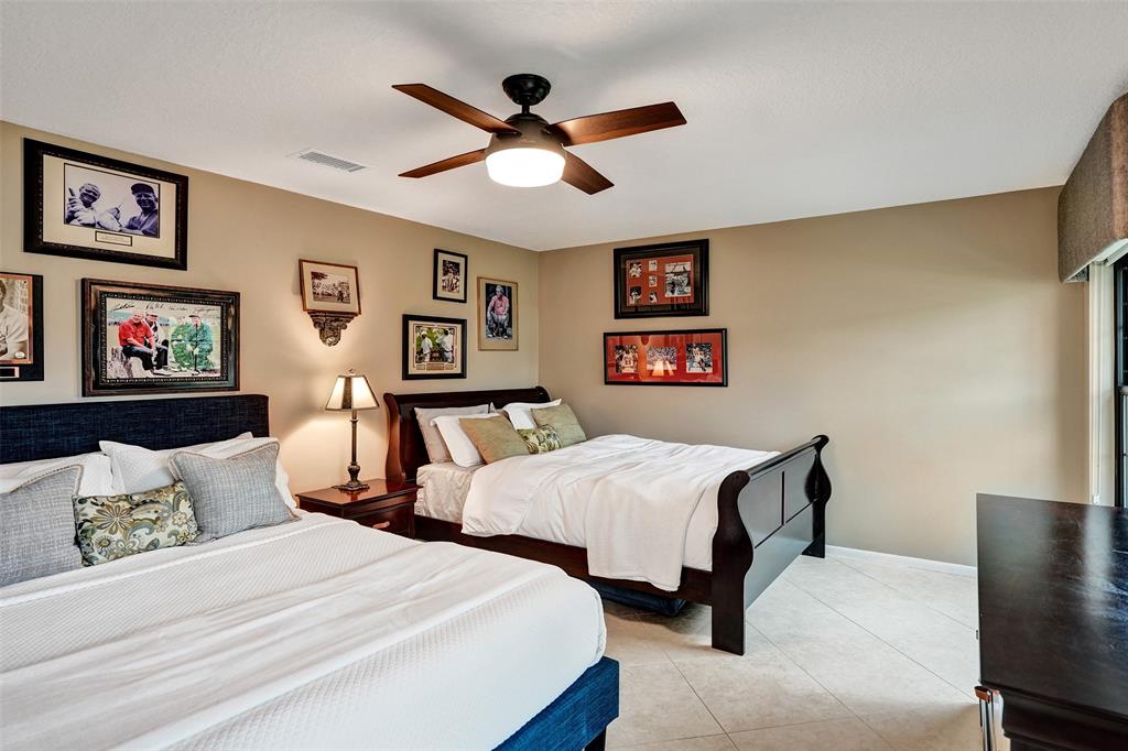 21357 Bridgeview Drive Boca Raton, FL 33428 - Photo 43 of 54 a bedroom with two beds and a chandelier