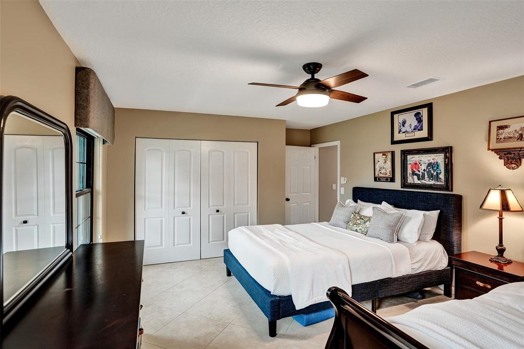 21357 Bridgeview Drive Boca Raton, FL 33428 - Photo 44 of 54 a bedroom with a bed and a chandelier