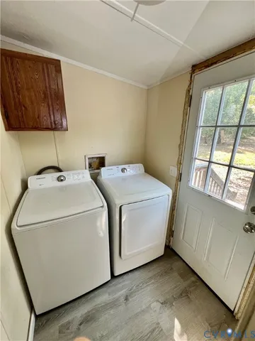 a large kitchen with kitchen island granite countertop a refrigerator a stove a sink dishwasher and wooden cabinets with wooden floor