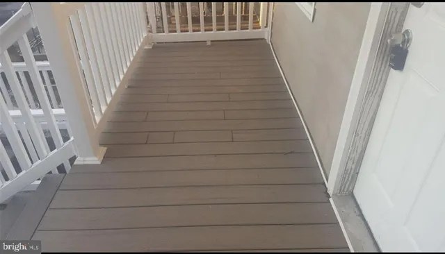 a view of staircase with white walls and railing