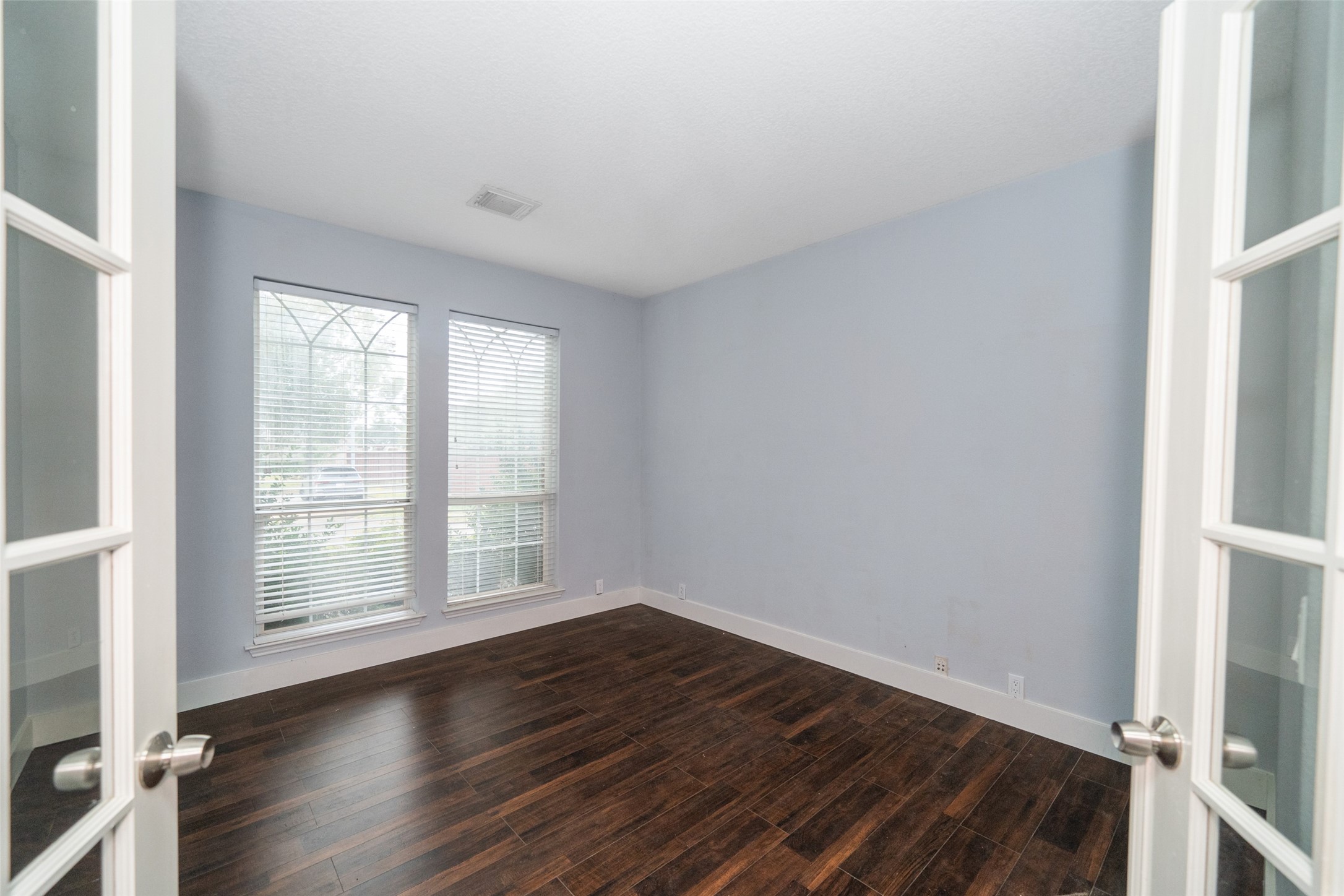 11534 Alpena Lane Houston, TX 77095 - Photo 13 of 28 an empty room with wooden floor and windows