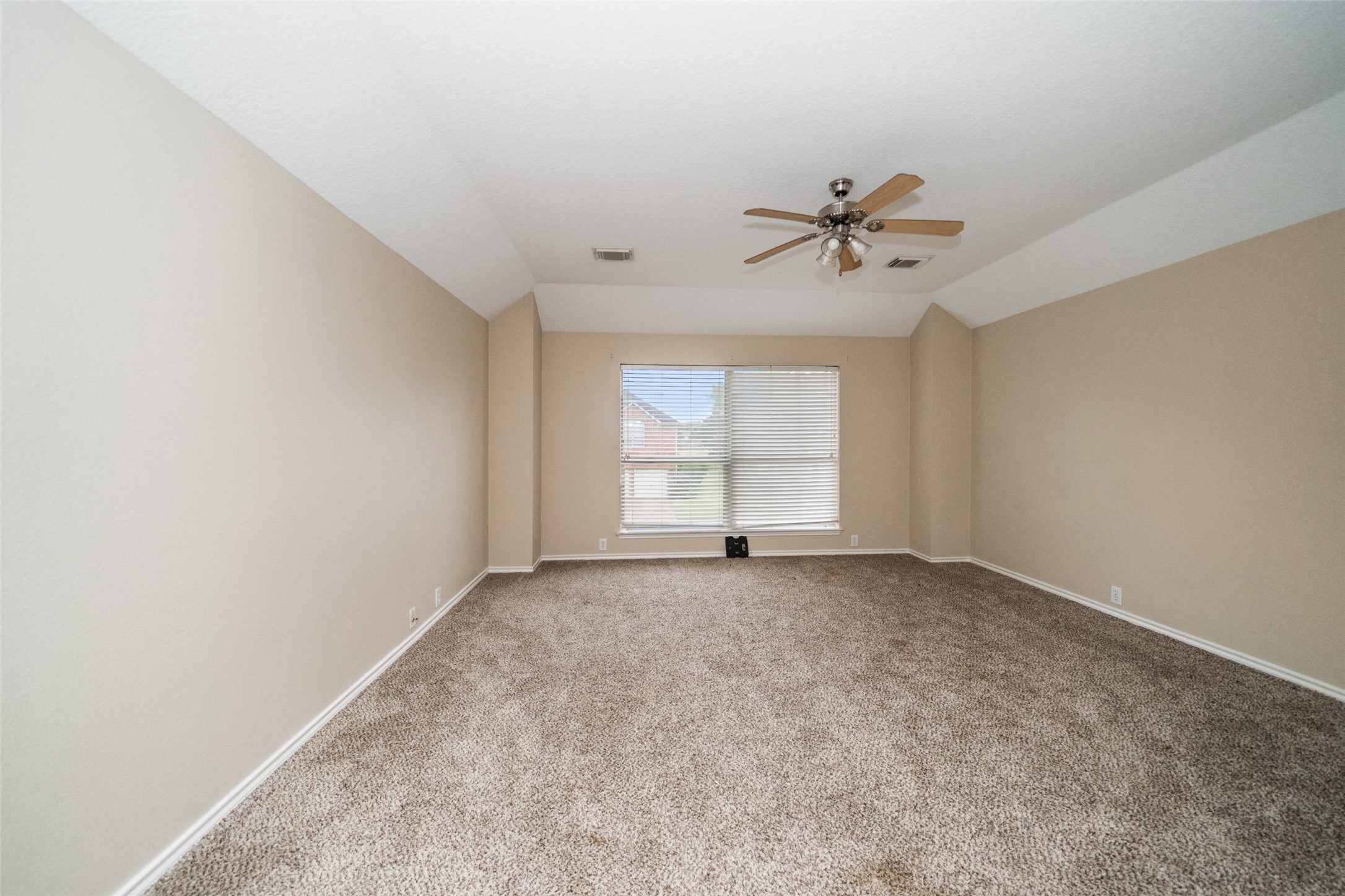 11534 Alpena Lane Houston, TX 77095 - Photo 21 of 28 an empty room with windows and ceiling fan view