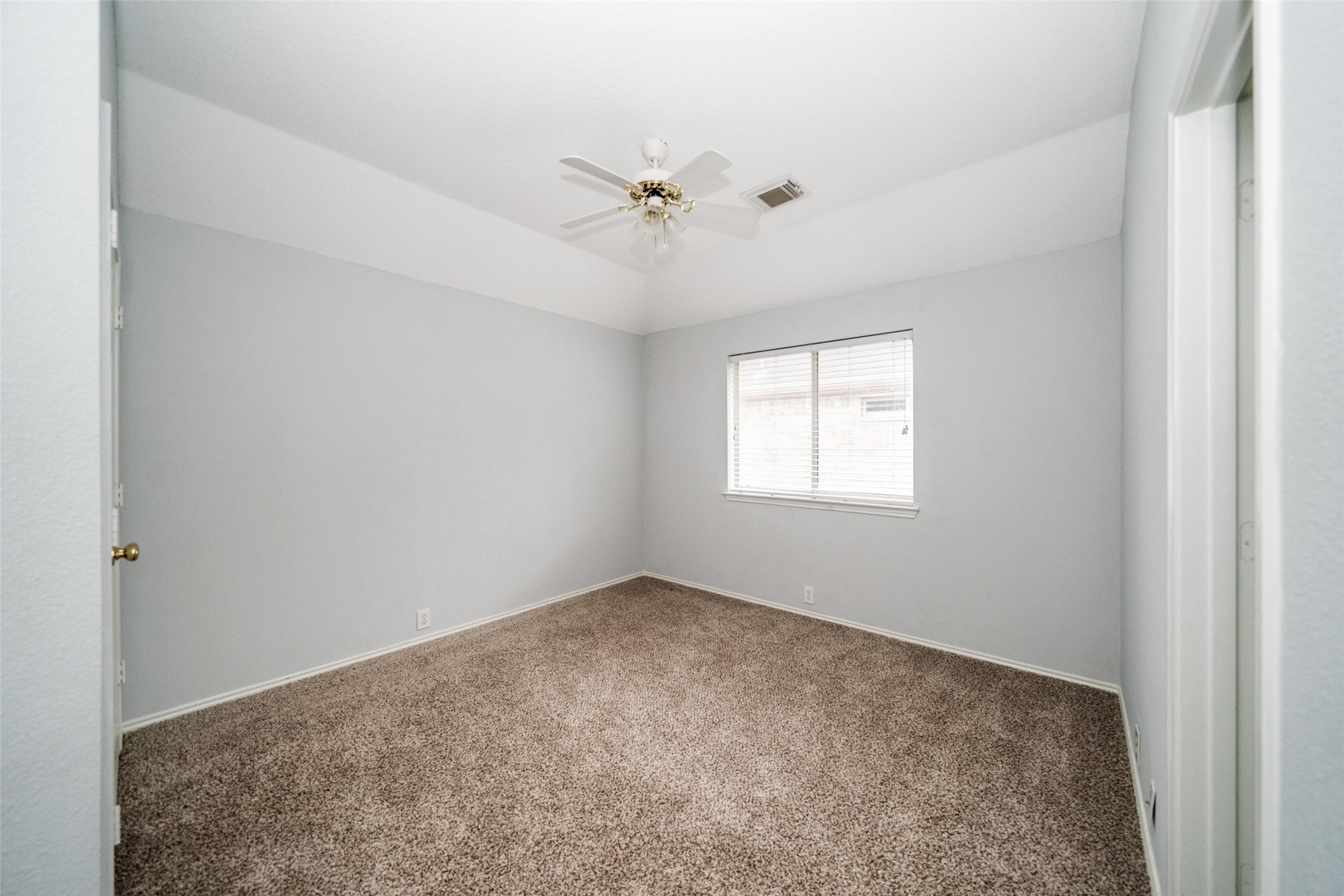 11534 Alpena Lane Houston, TX 77095 - Photo 23 of 28 an empty room with windows and ceiling fan