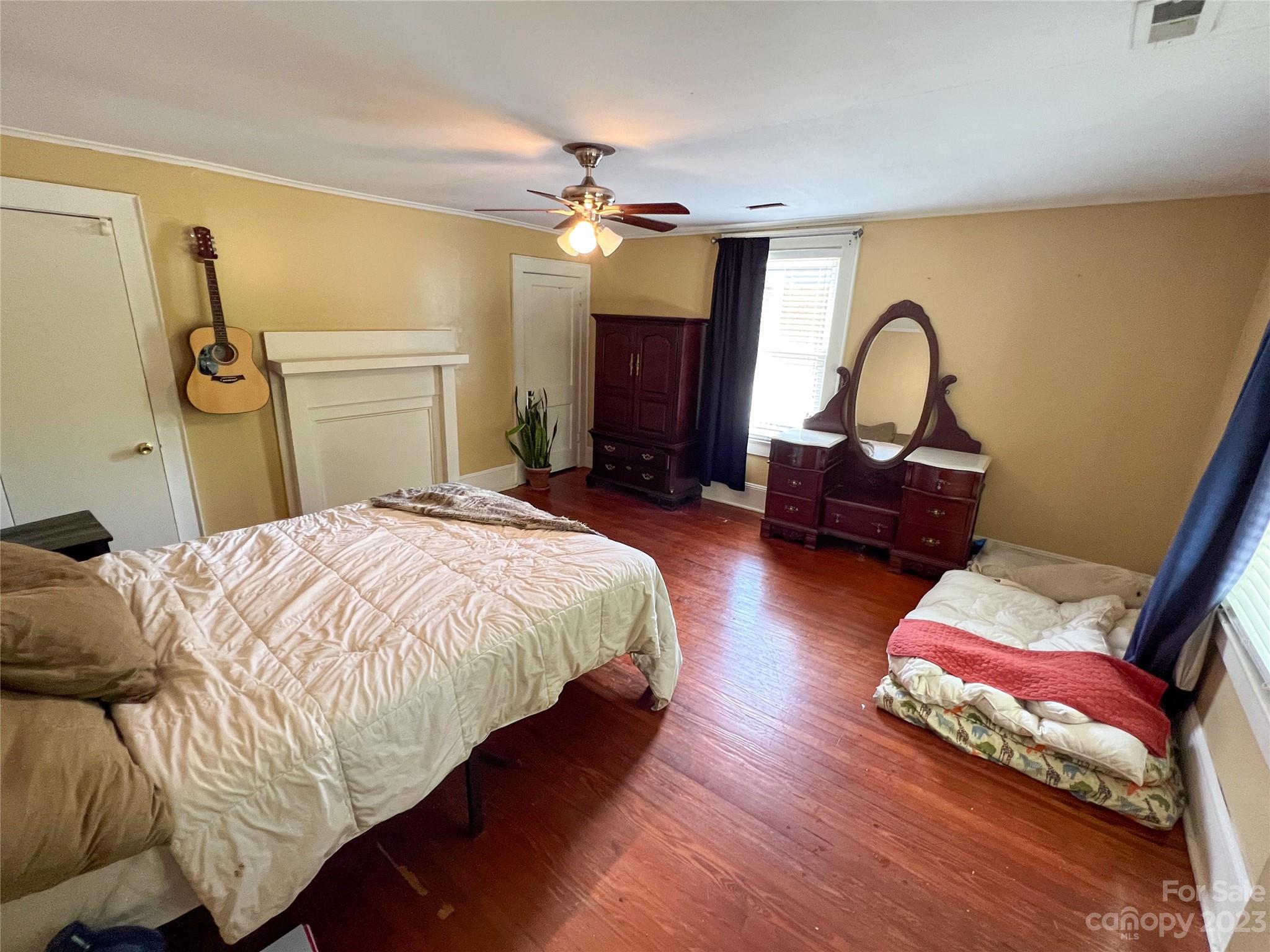 505 North Main Street Lenoir, NC 28645 - Photo 15 of 22 a bedroom with a bed couch and a chandelier