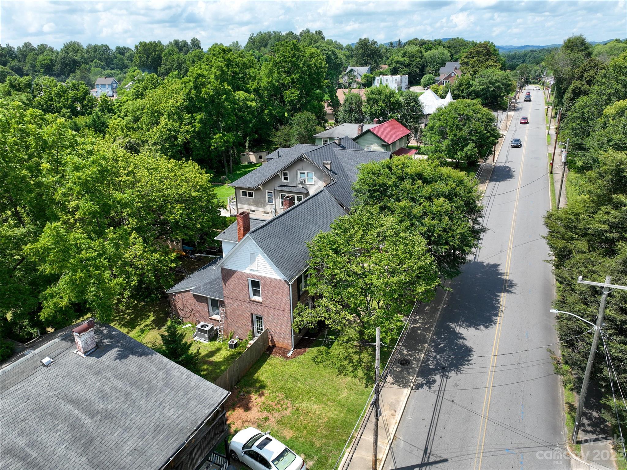 505 North Main Street Lenoir, NC 28645 - Photo 20 of 22 an aerial view of a house with a yard and greenery