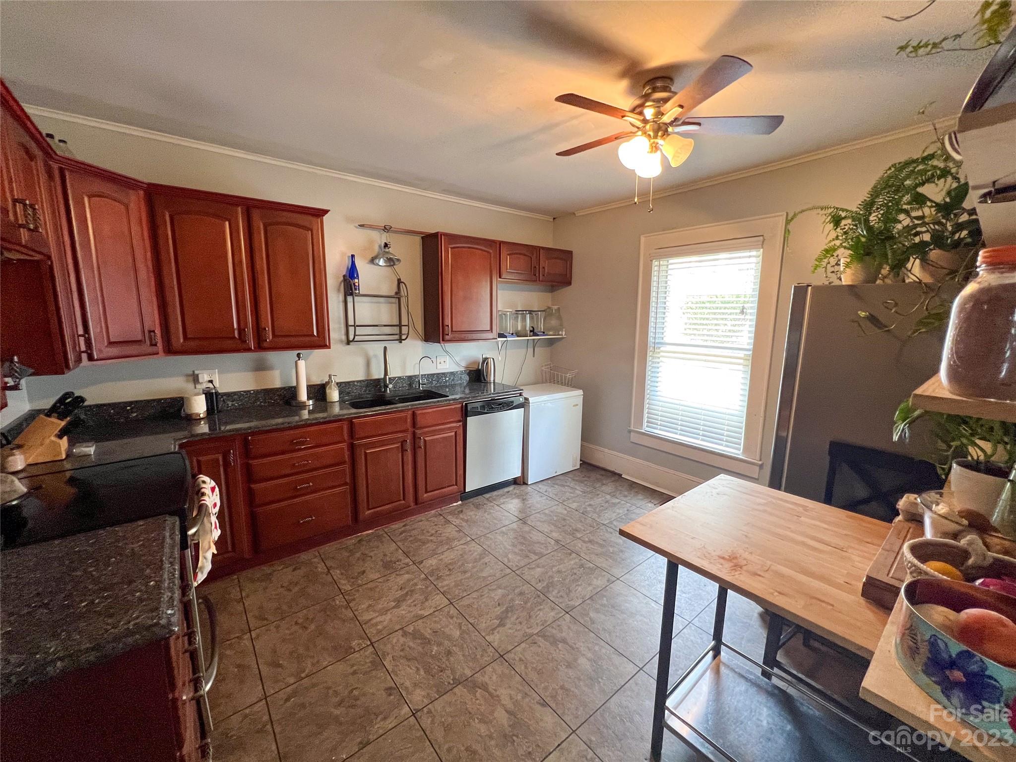 505 North Main Street Lenoir, NC 28645 - Photo 7 of 22 a kitchen with a stove a sink dishwasher and a stove with wooden cabinets