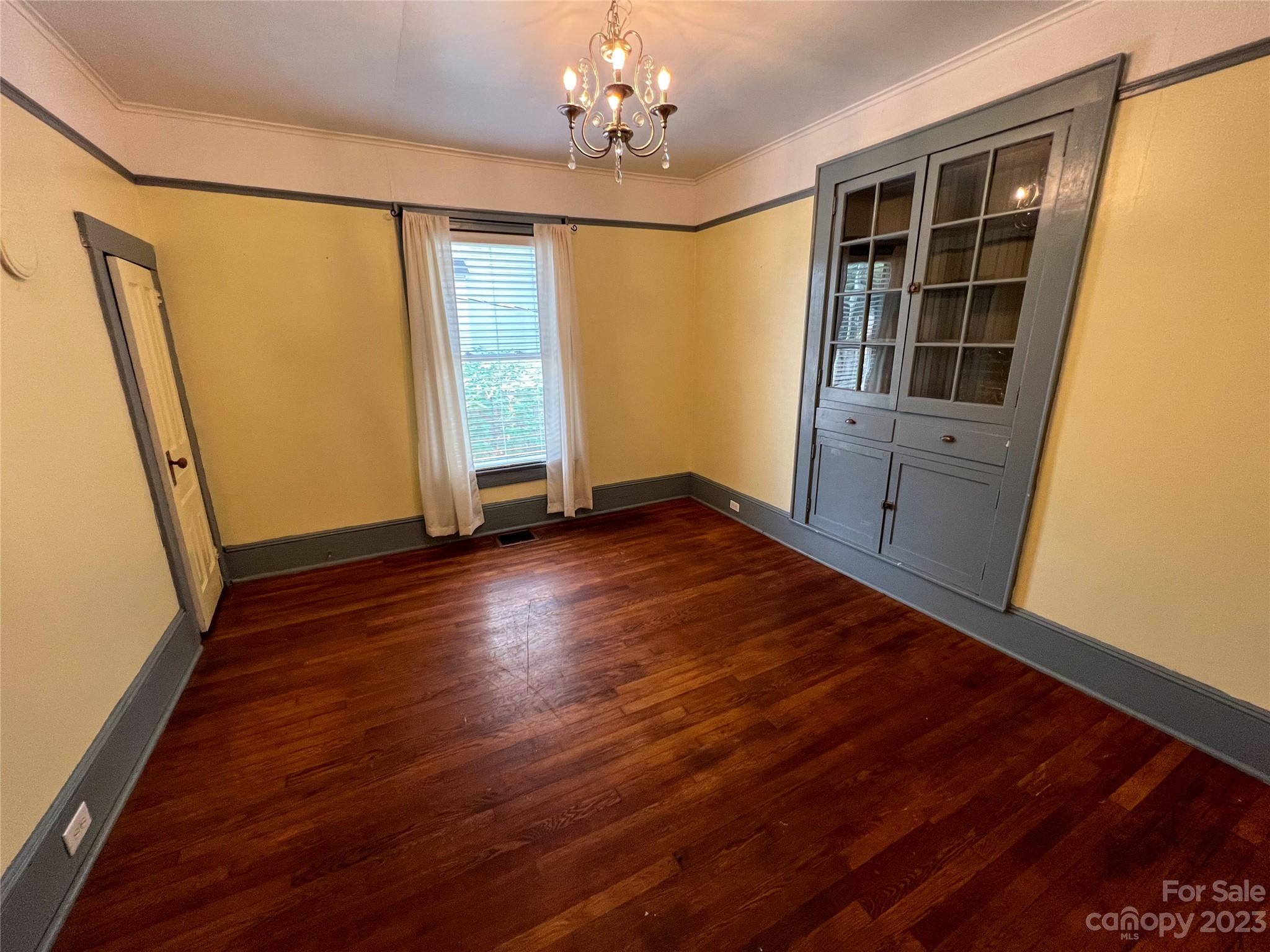 505 North Main Street Lenoir, NC 28645 - Photo 9 of 22 a view of empty room with wooden floor and fan