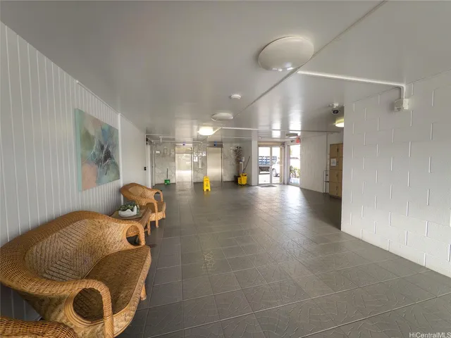 a lobby with furniture and wooden floor