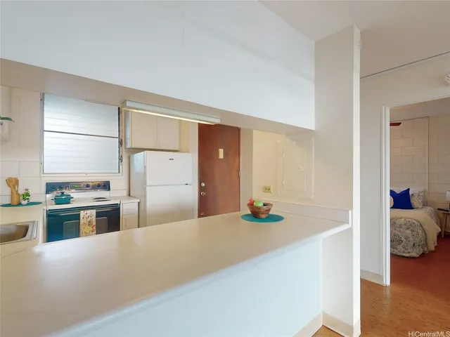 a kitchen with stainless steel appliances kitchen island sink refrigerator and stove