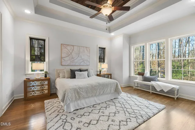 a bedroom with a bed wooden floor and furniture