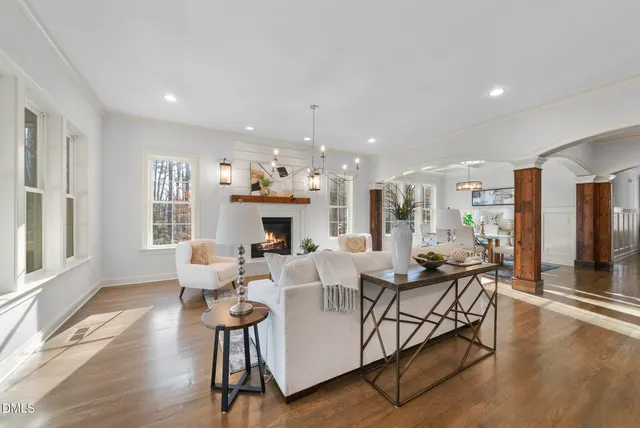 a view of a dining room with furniture wooden floor and a chandelier