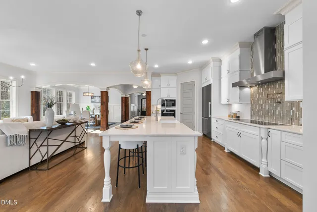 a bedroom with a large bed and a chandelier