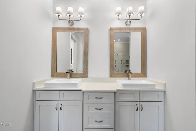 a dining room with wooden floor a chandelier a wooden table and chairs