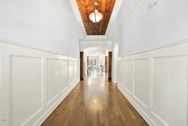 a view of a hallway with wooden floor and entryway