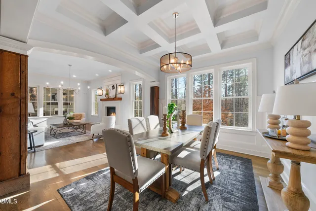 a view of a dining room with furniture wooden floor and chandelier