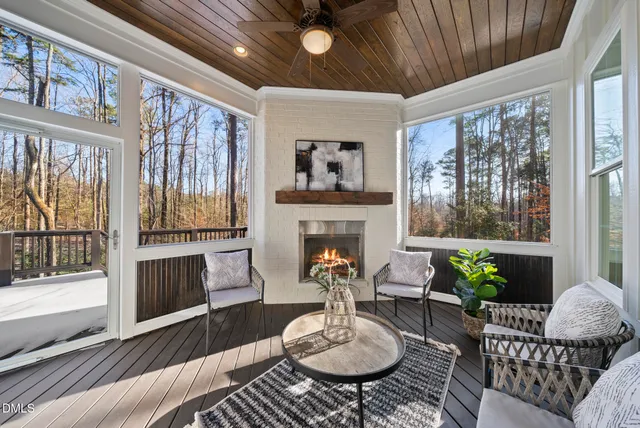 a living room with furniture a fireplace and a large window