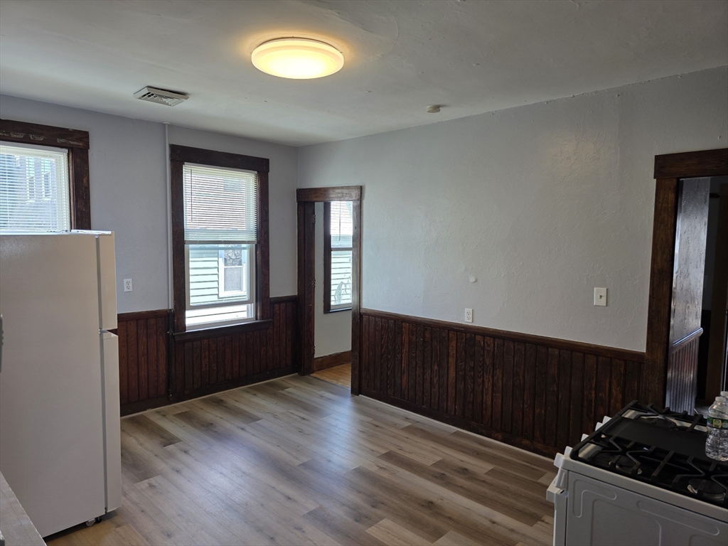 2 Hillside Street, Unit 3 Worcester, MA 01610 - Photo 13 of 30 a kitchen with a refrigerator and a stove top oven