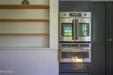 a close view of a stove a microwave and door