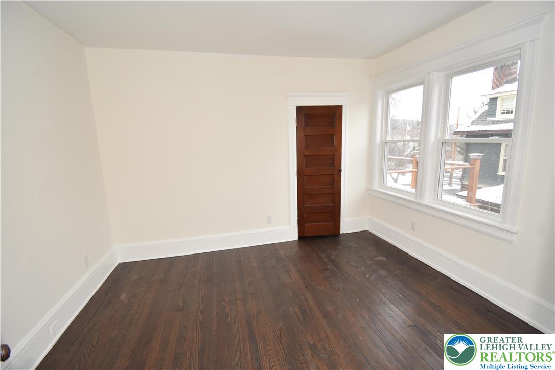 312 March Street, Unit 4 Easton, PA 18042 - Photo 4 of 8 an empty room with wooden floor and windows