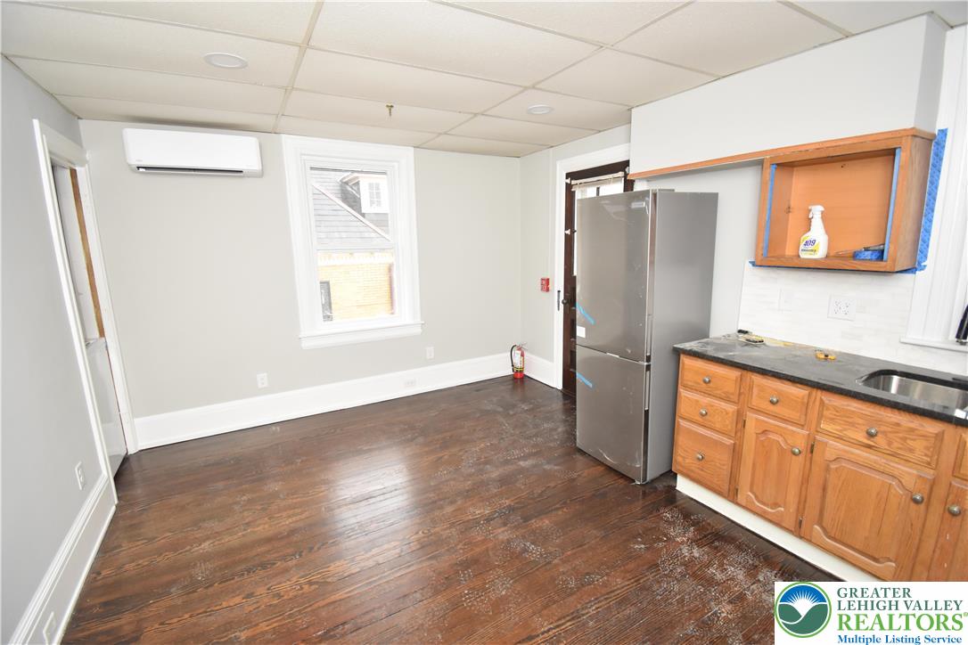 312 March Street, Unit 4 Easton, PA 18042 - Photo 7 of 8 a kitchen with stainless steel appliances granite countertop a refrigerator and a sink