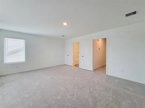 a view of an empty room and a window