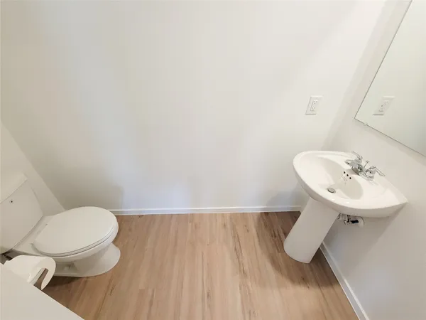 a bathroom with a sink toilet and a mirror