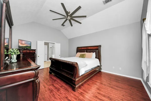a bedroom with a bed dresser and a window