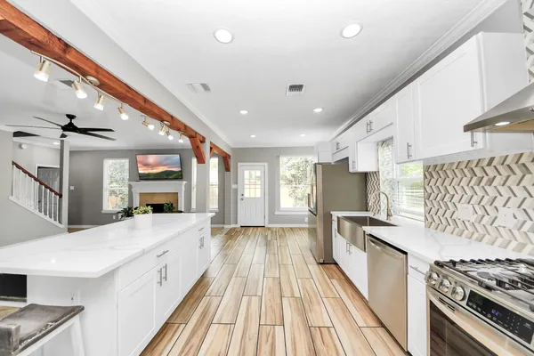 a kitchen with stainless steel appliances granite countertop a stove and a refrigerator